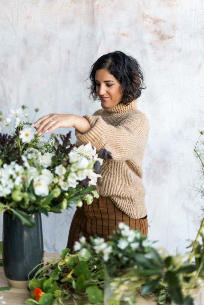 Amy Nicole making a floral arrangement with line flowers