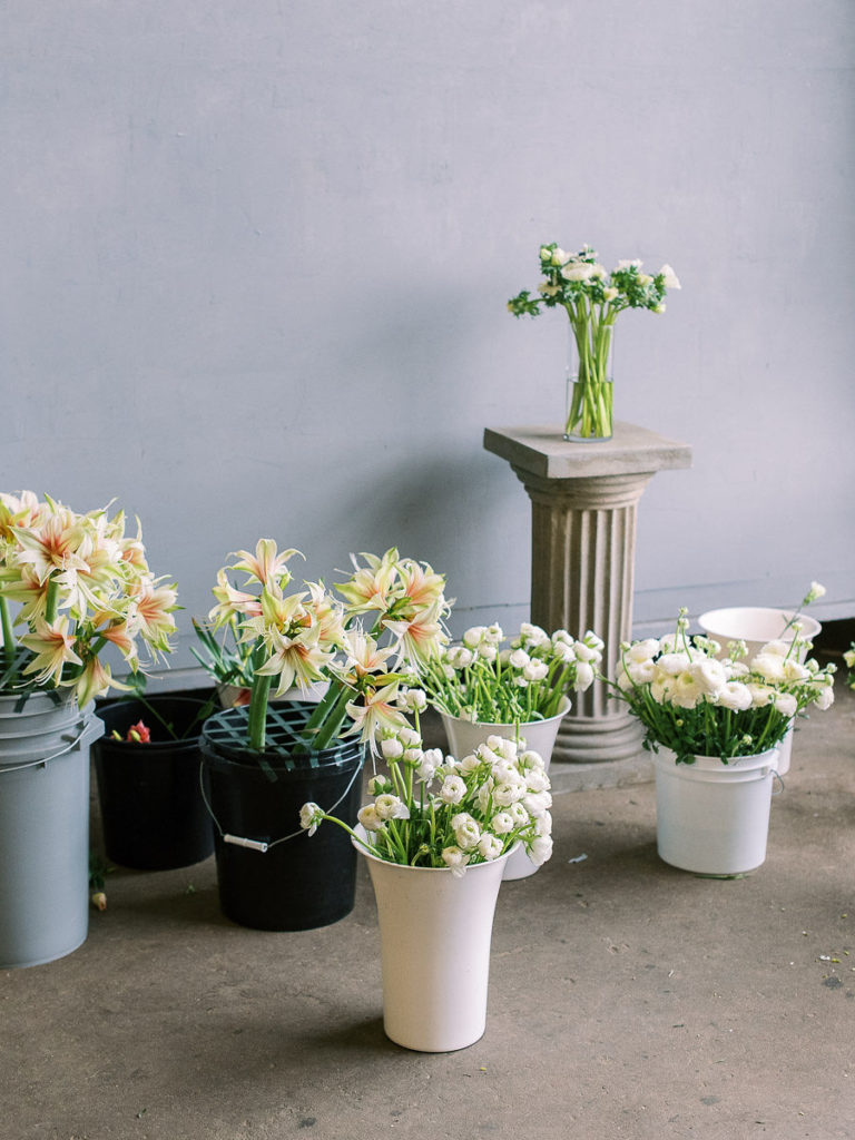 A photo of bouquets of flowers from Amy Nicole at Amy Nicole Floral arranged in buckets as she prepares to show her students how to press flowers.