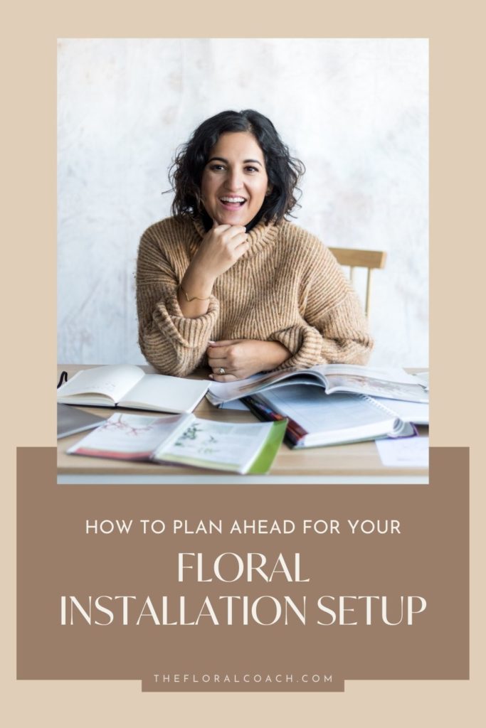 Amy Balsters smiles while sitting at her desk planning her floral installation setup; image overlaid with text that reads How to Plan Ahead for Your Floral Installation Setup.