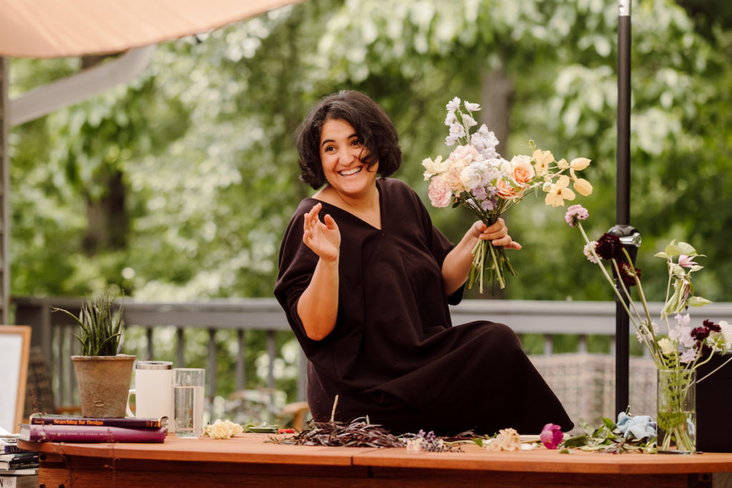 Amy from The Floral Coach smiles as she shows her floral arrangement class a demonstration; photo by @karenobrist