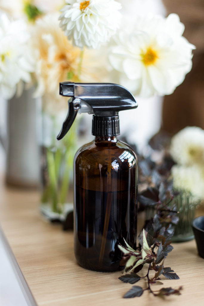 How to Keep Flowers Fresh and Vibrant. Close-up photo of an amber colored spray bottle.