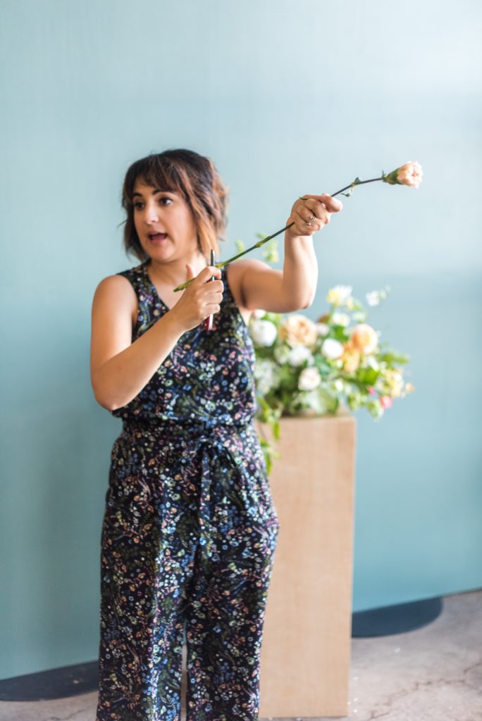 Amy Balsters, The Floral Coach® teaching while using a florist's knife.