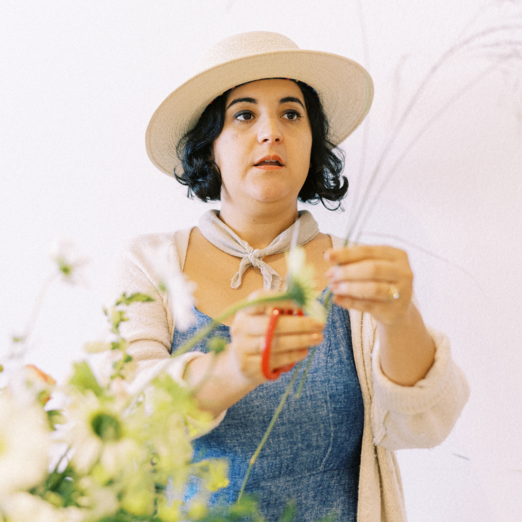 Image of Amy Balsters, The Floral Coach® holding florist shears as she demonstrates on grasses